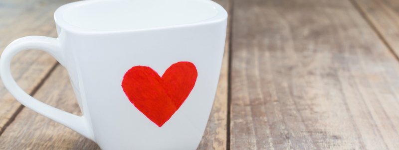 A white mug with a red heart on it