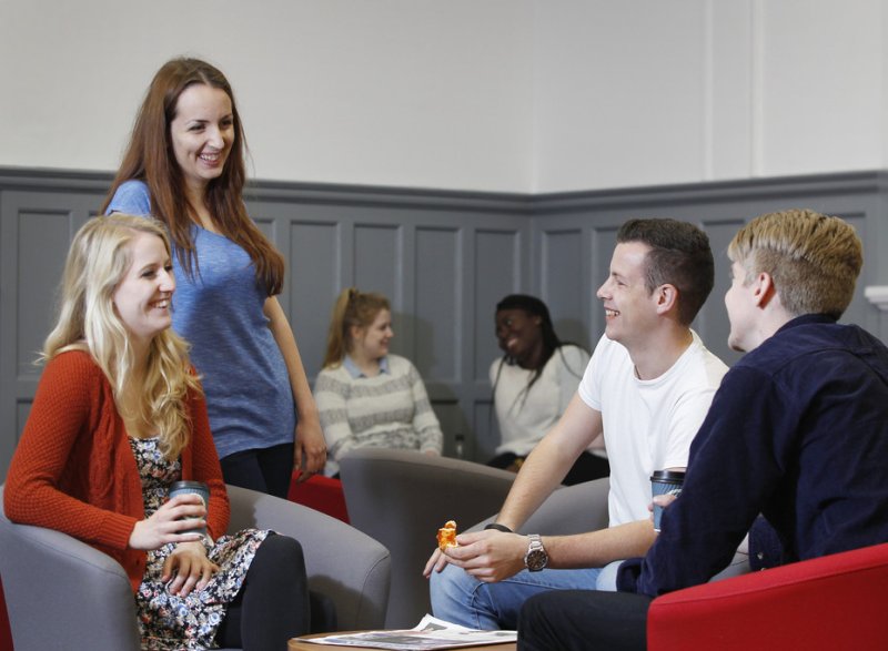 Portsmouth students chatting in a common room environment