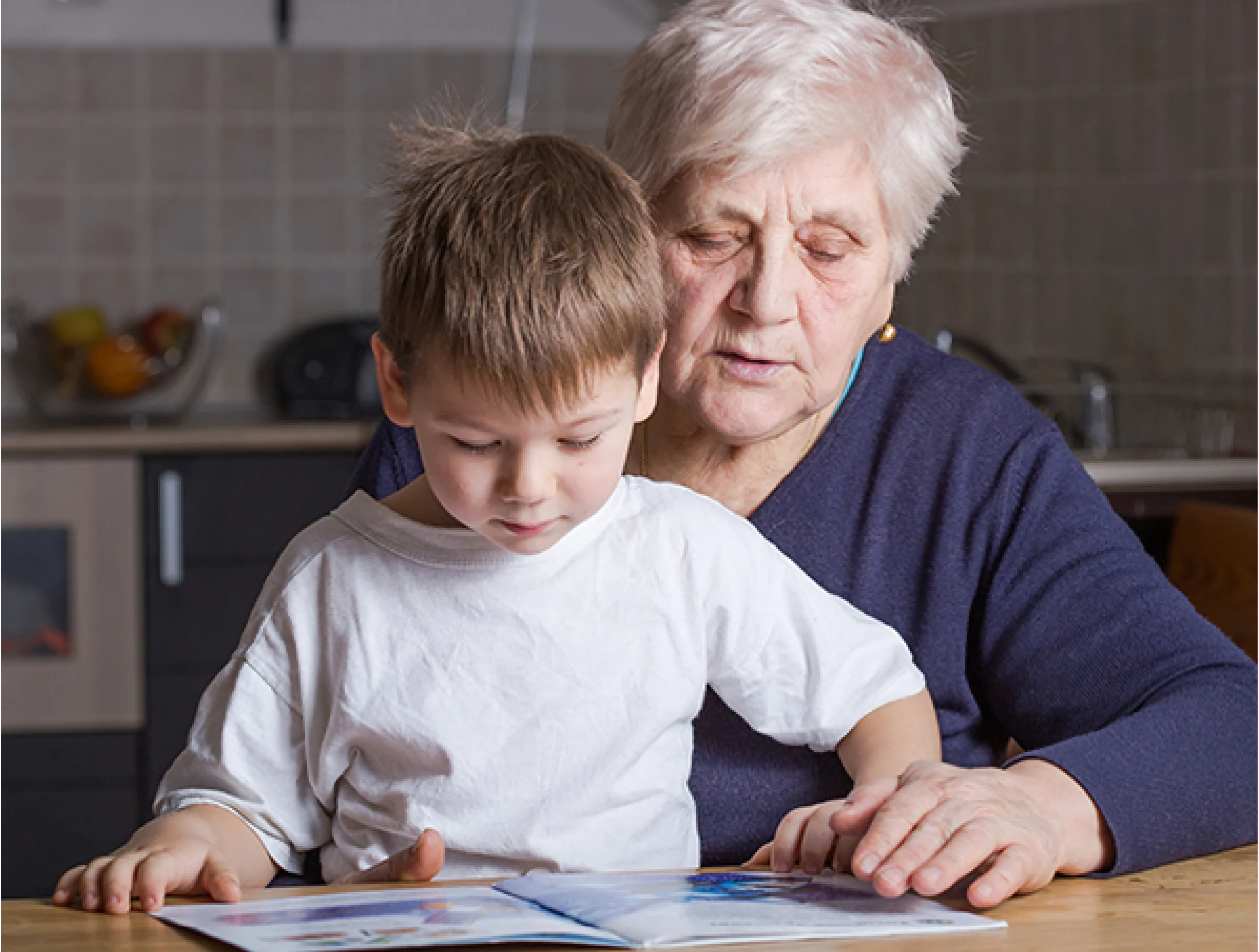 An older woman and a young boy reading